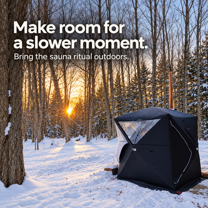 Willowybe insulated outdoor sauna tent with chimney shown among snow-covered trees at sunset