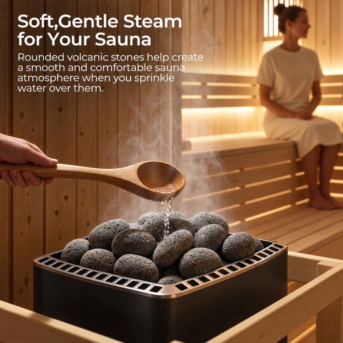 Wooden ladle pouring water onto rounded Willowybe sauna stones in a heater, with rising steam and a seated sauna user in the background