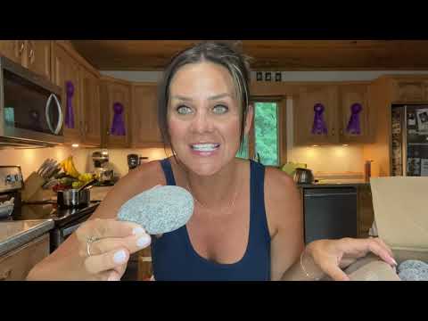 Customer holding a rounded volcanic sauna stone in product review video thumbnail
